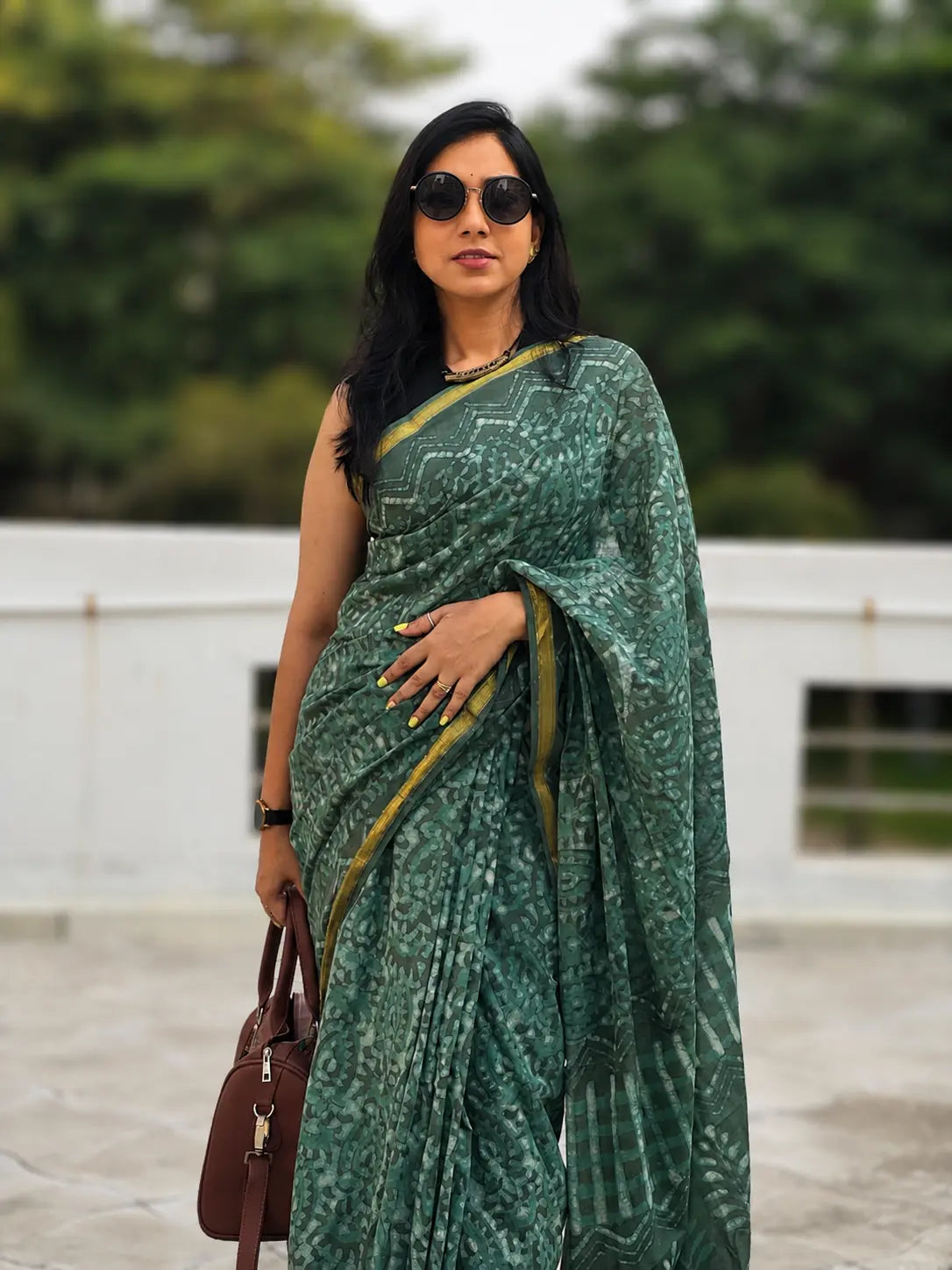 Woman wearing an elegant saree suitable for office wear