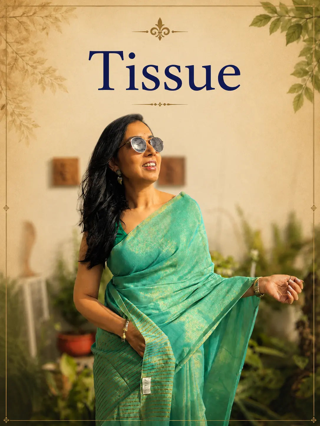 Elegant woman draped in a sea green tissue saree with subtle gold zari detailing, posing gracefully amidst a lush garden backdrop for the Tiulip Tissue Saree Collection.