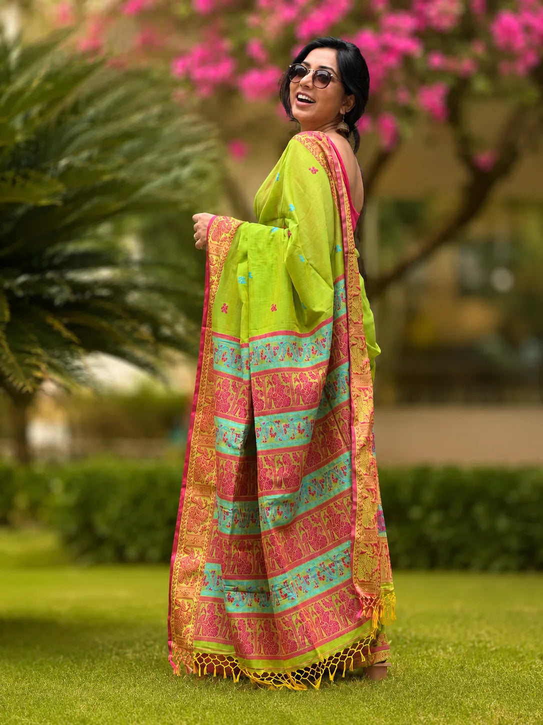 Handwoven cotton Jamdani saree in light green and red with traditional motifs