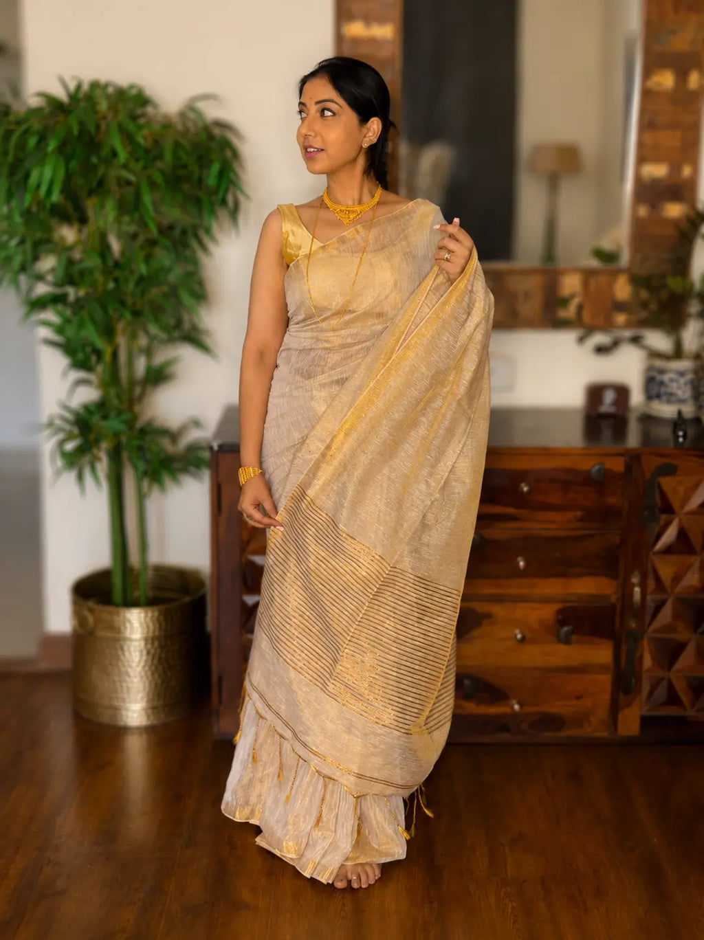 White and gold tissue saree with elegant drape by TIULIP