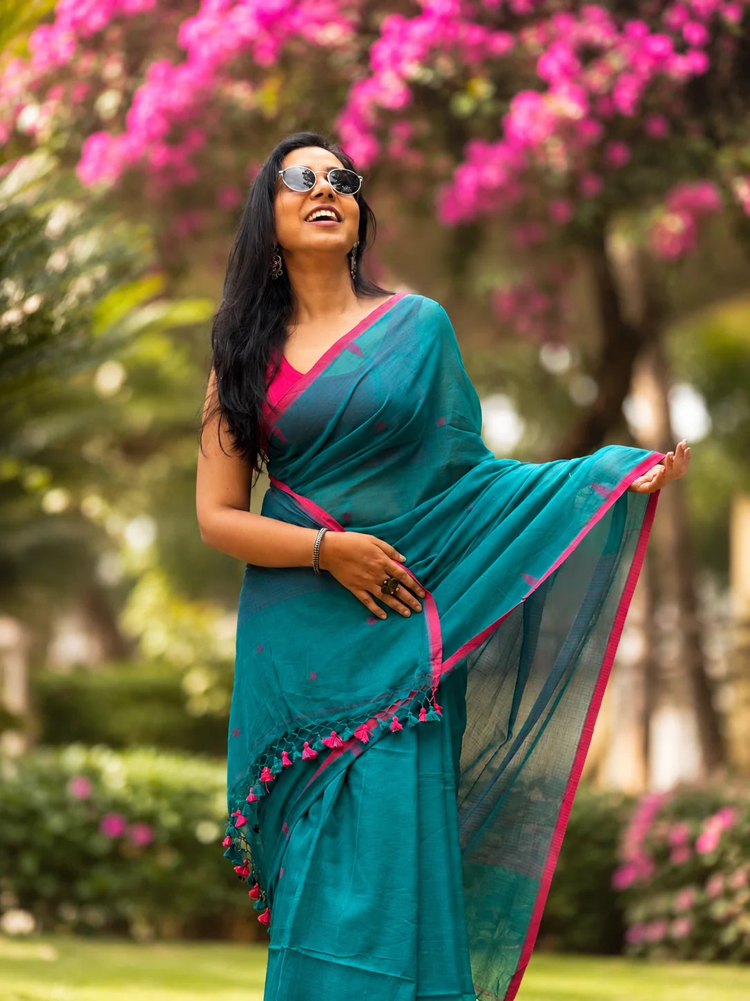 Woman wearing blue handwoven cotton Jamdani saree with traditional motifs