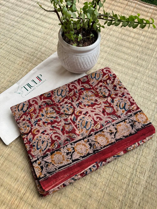 Charulekha hand printed red cotton Kalamkari saree with traditional artistic motifs in soft breathable cotton for office wear, festive occasions, and everyday elegance