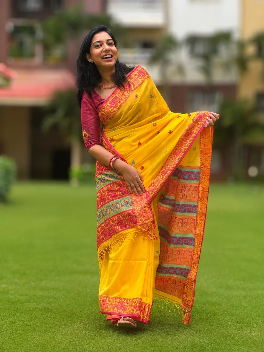 Handwoven cotton Jamdani saree in yellow and red with traditional motifs