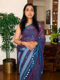 Woman wearing purple handwoven cotton Jamdani saree with traditional motifs