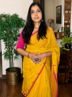Woman wearing yellow handwoven cotton Jamdani saree with traditional motifs