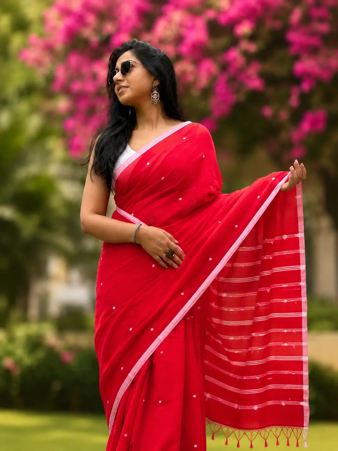 Woman wearing red handwoven cotton Jamdani saree with traditional motifs