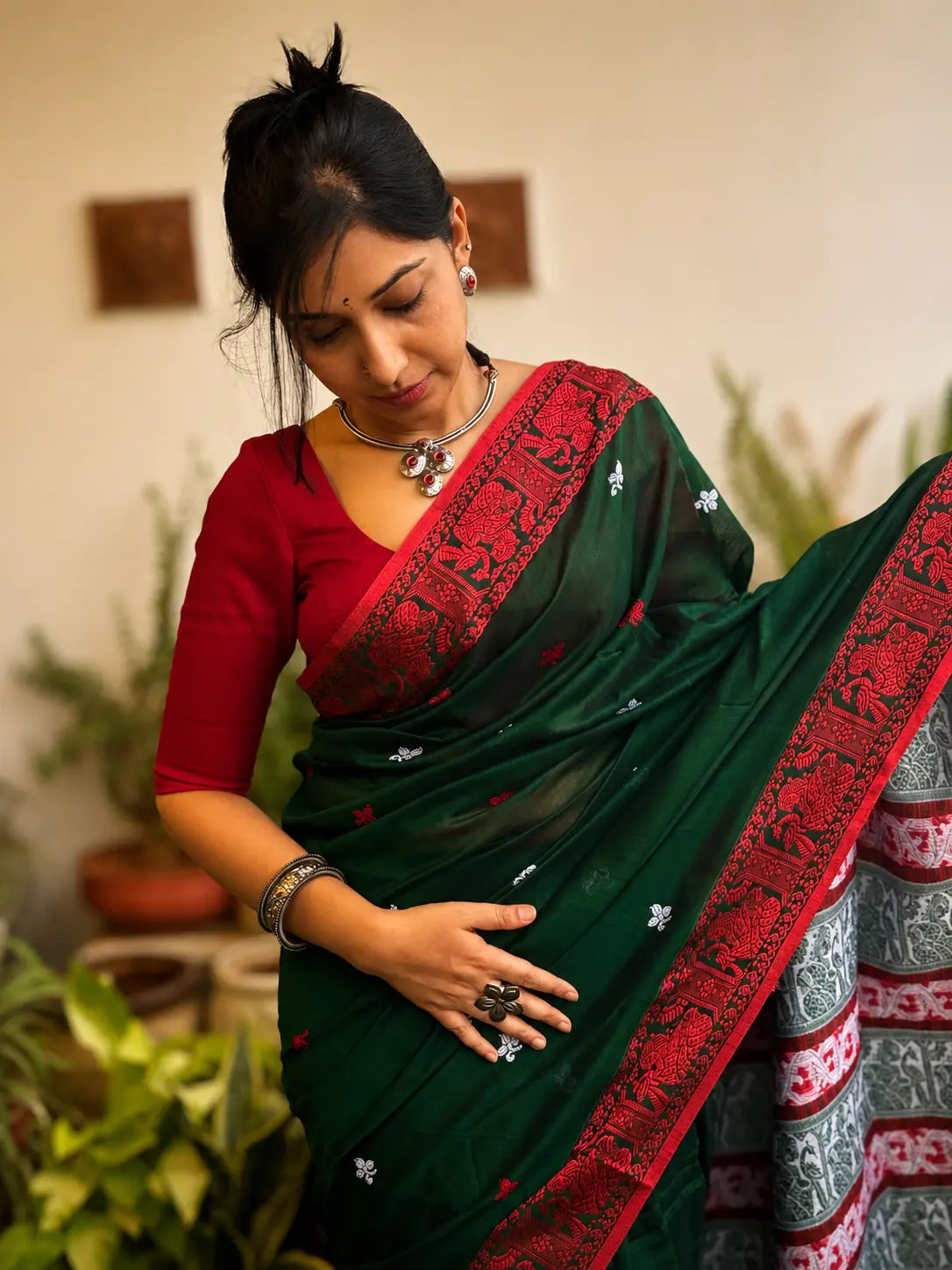 Handwoven cotton Jamdani saree in dark green and red with traditional motifs