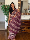 Woman wearing red handwoven Kota Doria saree with traditional woven design