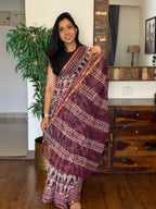 Woman wearing red handwoven Kota Doria saree with traditional woven design