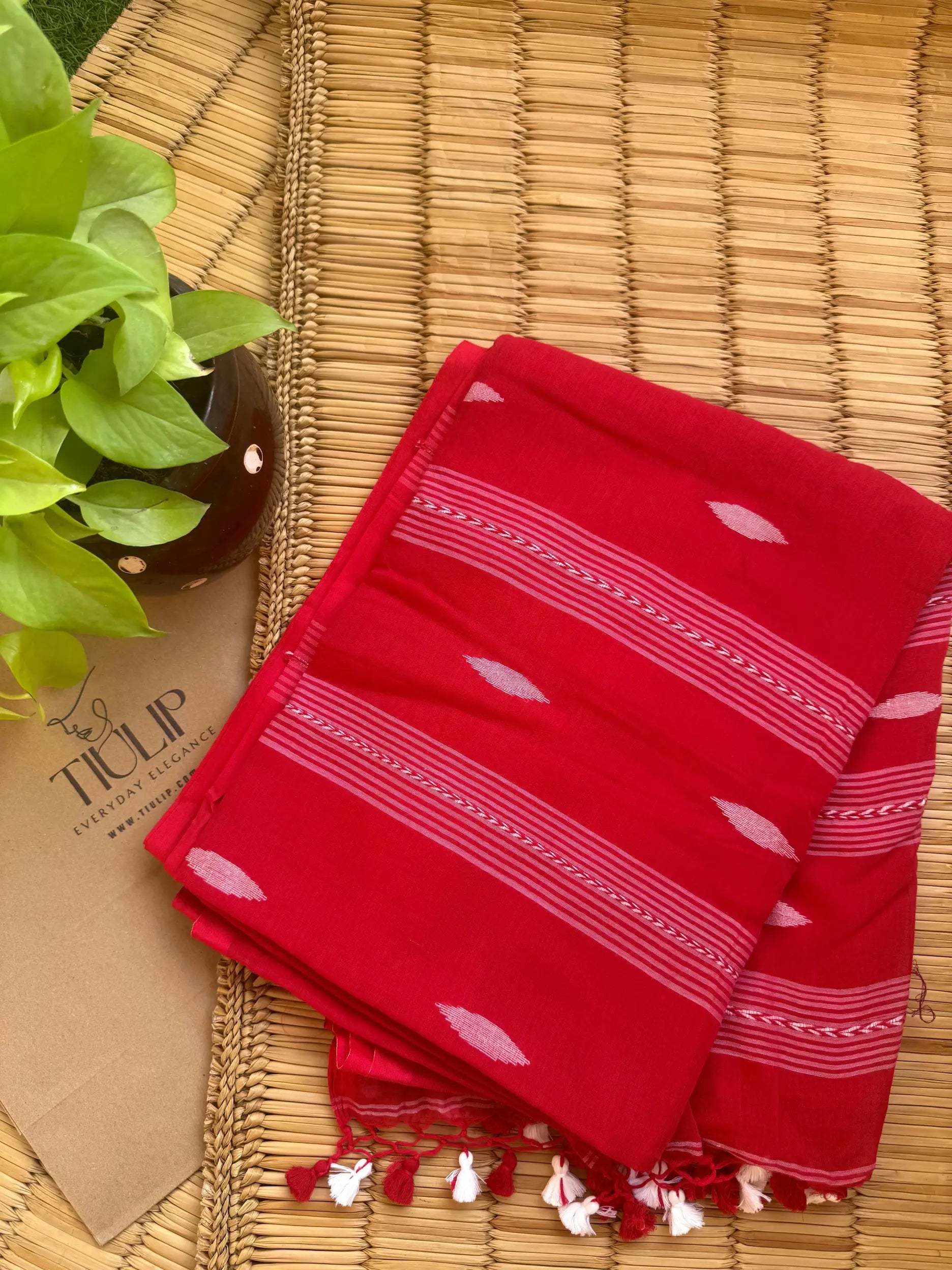 Red handwoven cotton Jamdani saree with traditional woven patterns