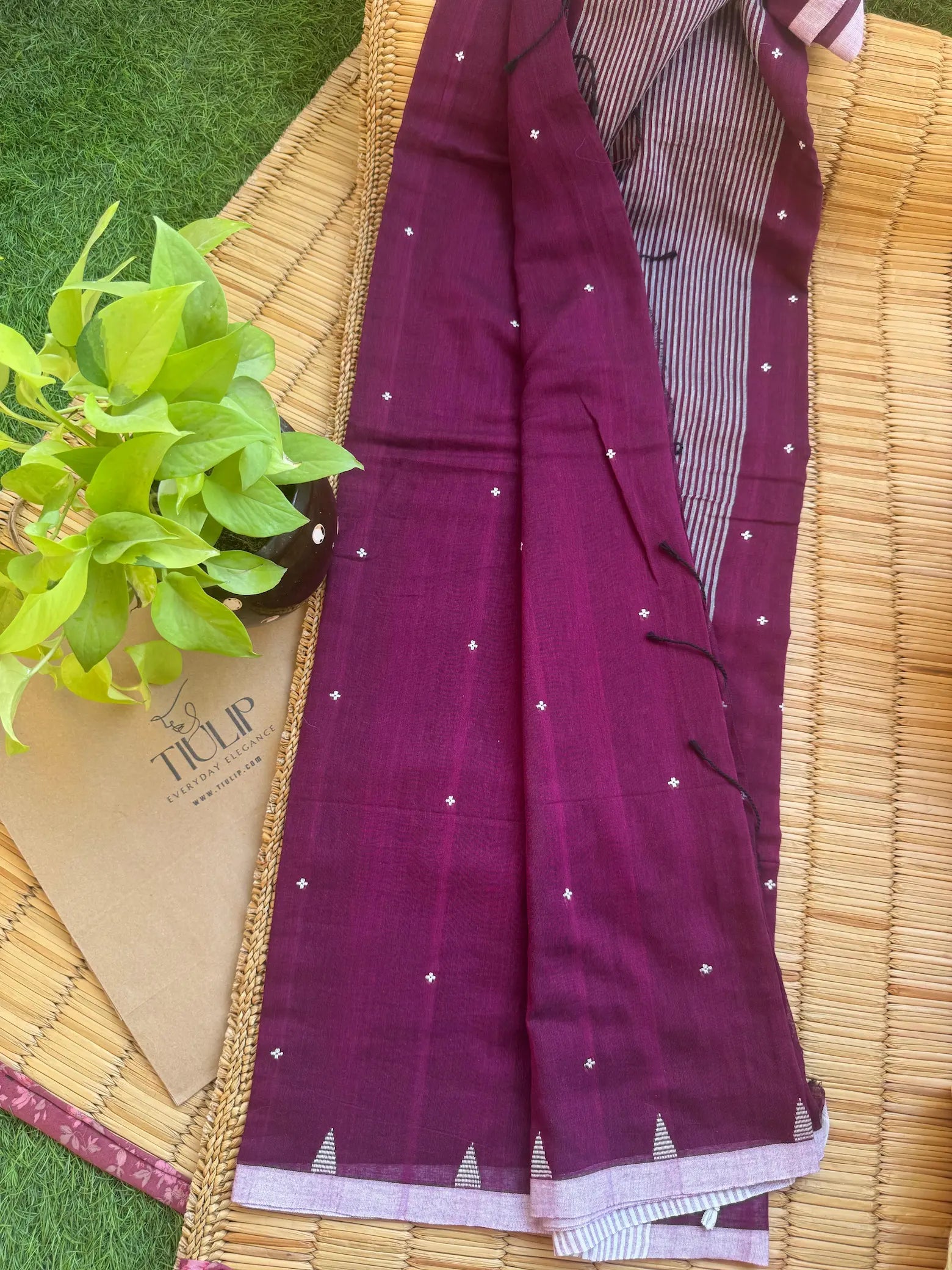 Purple handwoven cotton Jamdani saree with traditional woven patterns