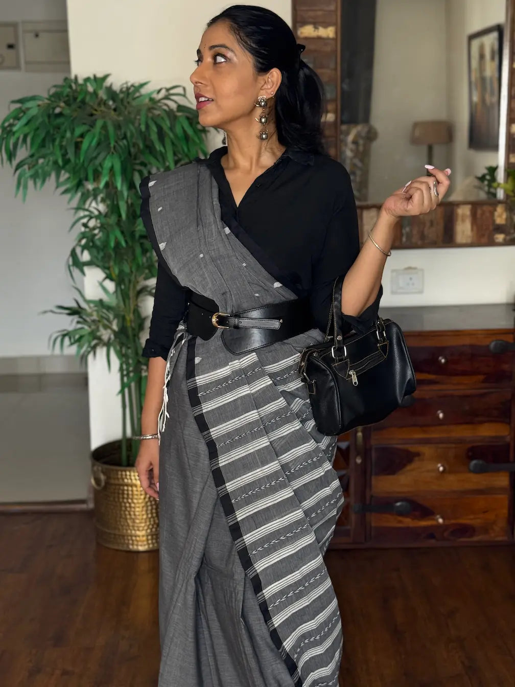 Woman wearing handwoven cotton Jamdani saree with traditional motifs