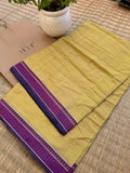 Kadambini pure handwoven yellow ochre Dhaniakhali cotton saree with purple border in soft breathable cotton for office wear, festive mornings, and everyday elegance