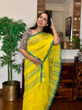 Woman wearing yellow handwoven cotton Jamdani saree with traditional motifs