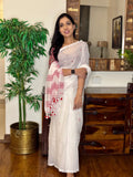 Woman wearing white handwoven cotton Jamdani saree with traditional motifs
